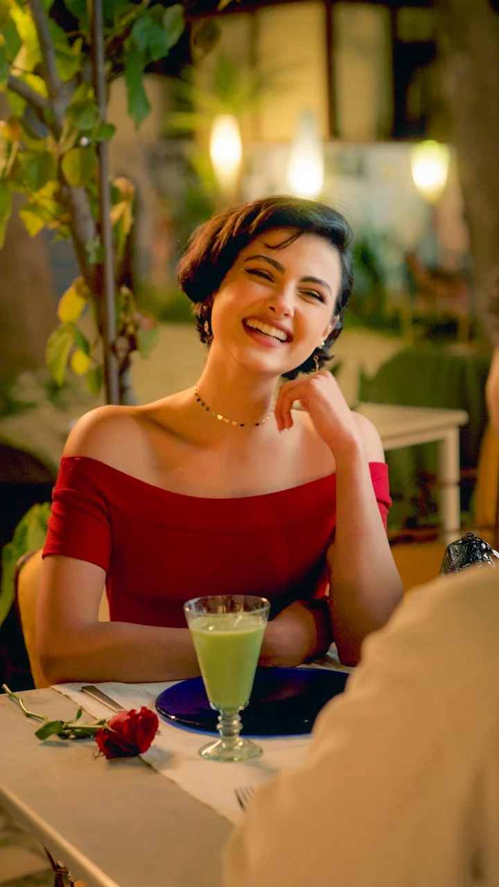 Samsung video 3: a woman in a red dress seated at a restaurant