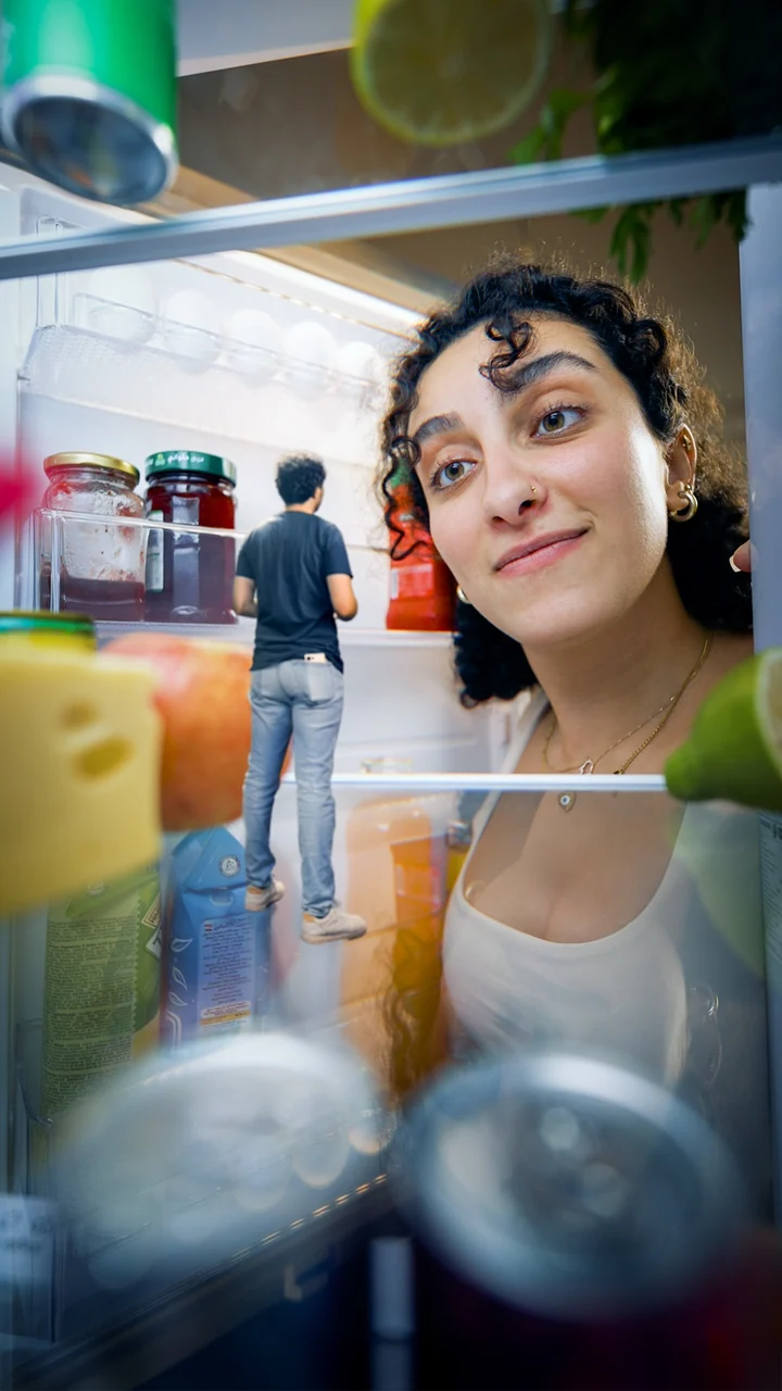 Samsung video 4: a woman looking inside a refrigerator