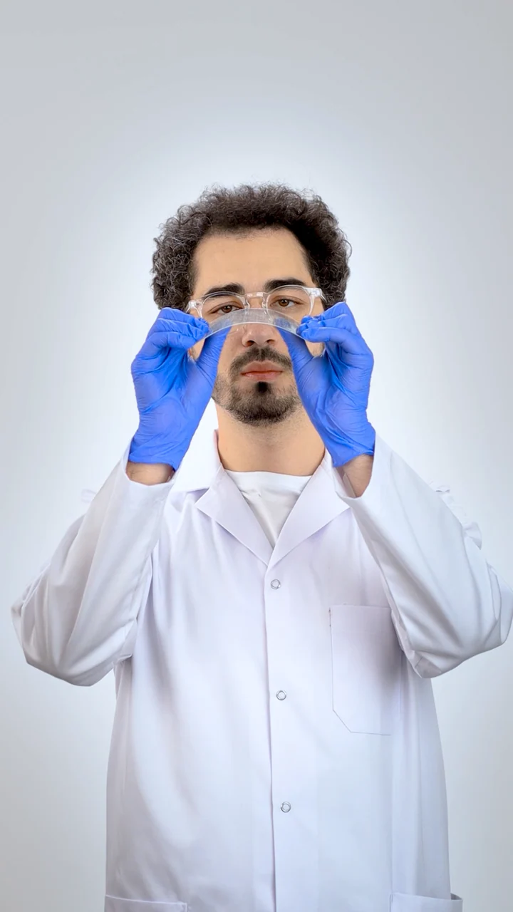 Samsung video 5: Baha Lajmi examining a transparent strip while wearing laboratory gloves